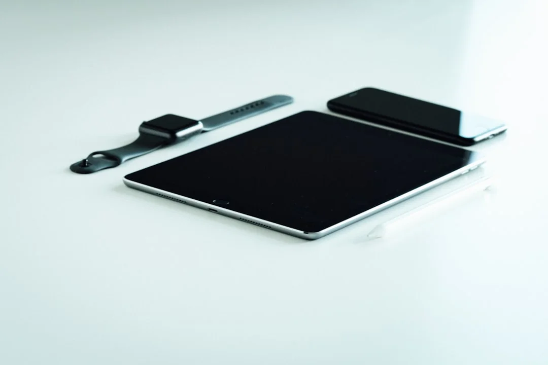 Dual monitors on a desk, showcasing web design in a modern office setting.